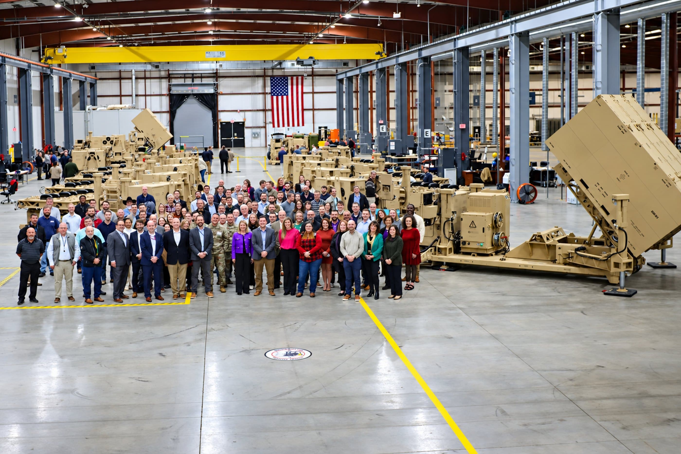 The Leidos Defense team gathered on the factory floor with launchers in production